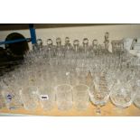 A COLLECTION OF CUT GLASS ETC, to include nine decanters, red and white wine glasses, brandy, sherry