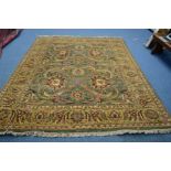 A KARABAGH STYLE CARPET SQUARE, green ground and multi strap border, 209cm x 242cm