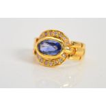 A MODERN SAPPHIRE AND DIAMOND OVAL CLUSTER RING, oval mixed cut sapphire measuring approximately 8.