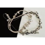 A PANDORA CHARM BRACELET AND NECKLACE, the bracelet designed as a plaited black cord suspending