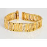 A MODERN ROBERTO COIN 18CT GOLD DIAMOND AND RUBY BRACELET, bark textured panel links, measuring