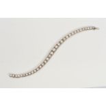 AN ART DECO GRADUATED DIAMOND LINE BRACELET, brilliant cut diamonds, each set to a box setting