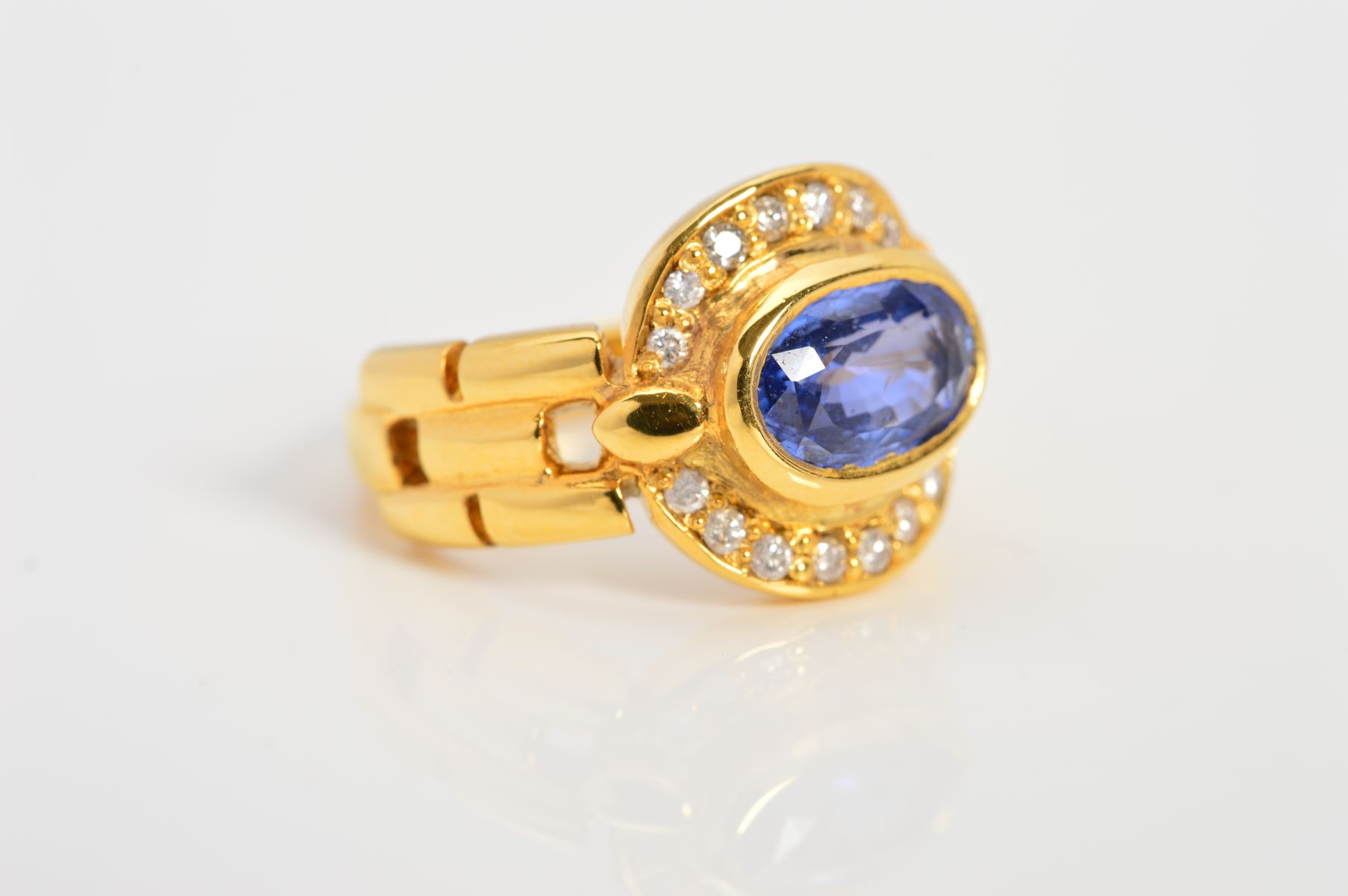 A MODERN SAPPHIRE AND DIAMOND OVAL CLUSTER RING, oval mixed cut sapphire measuring approximately 8. - Image 2 of 4