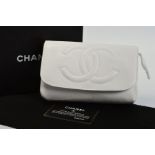 CHANEL WHITE COSMETIC CLUTCH BAG, the flap front with double 'C' padded motif, press stud