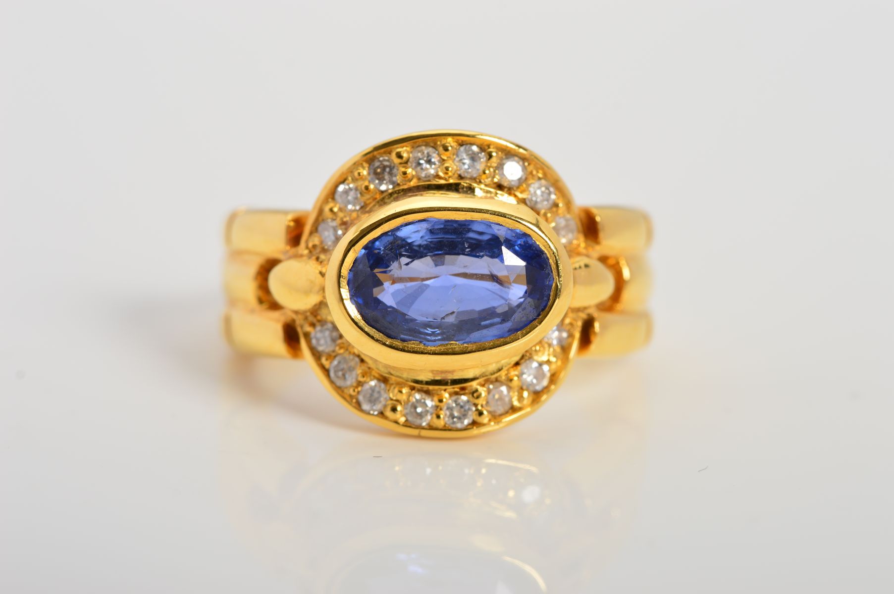 A MODERN SAPPHIRE AND DIAMOND OVAL CLUSTER RING, oval mixed cut sapphire measuring approximately 8. - Image 4 of 4
