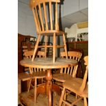 A PINE CIRCULAR KITCHEN TABLE, diameter 89cm, together with four beech chairs (5)