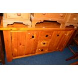 A STAINED PINE SIDEBOARD, with three central drawers, width 154cm x depth 47cm x height 79cm