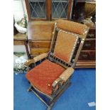 AN EDWARDIAN MAHOGANY AMERICAN ROCKING CHAIR