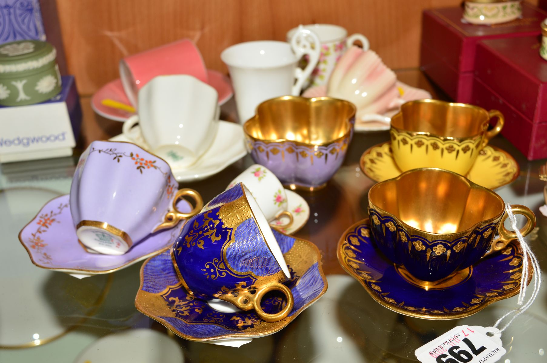 A GROUP OF COALPORT CABINET MINIATURE CUPS AND SAUCERS, to include two cups and saucers, one