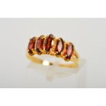 A 9CT GOLD GEM DRESS RING, designed as five marquise shape red gems, assessed as garnets set in a