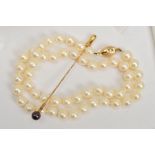 A CULTURED PEARL NECKLACE WITH 9CT GOLD CLASP AND A CULTURED PEARL STICKPIN, the necklace a single