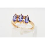 A TANZANITE AND DIAMOND DRESS RING, designed as a line of three marquise shape tanzanites each