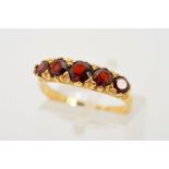AN 18CT GOLD FIVE STONE GARNET RING, designed as a graduated row of five circular garnets to the