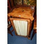 A VICTORIAN WALNUT SINGLE DOOR MUSIC CABINET, fretwork gallery, flanked by roundels to front corners