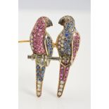 A GEM PARROT BROOCH, designed as two parrots on a perch, both set with circular sapphires, rubies