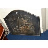 A CAST IRON FIRE BACK of a woodland scene, width 79cm x height 67cm