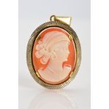 A CAMEO PENDANT, of oval outline, the cameo depicting a woman in profile to the diamond cut