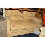 A FLORAL CREAM UPHOLSTERED TWO SEATER BED SETTEE