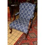 A REPRODUCTION MAHOGANY GAINSBOROUGH CHAIR, covered with blue geometric upholstery, foliate