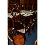 A MAHOGANY TWIN PEDESTAL TABLE, two additional leaves and eleven matching chairs (14)