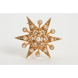 A 9CT GOLD SPLIT PEARL STAR BROOCH, of star outline set with tiers of vari-sized split pearls with