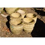 A SET OF FIVE COMPOSITE CIRCULAR PLANTERS with rope and floral decoration (5)