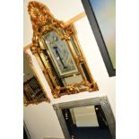 A MODERN FOLIATE GILT FRAMED WALL MIRROR together with a silvered wall mirror (2)