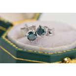 A PAIR OF 18CT WHITE GOLD TREATED BLUE DIAMOND STUD EARRINGS, each designed as a brilliant cut