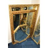 A LARGE FOLIATE GILT FRAMED BEVELLED EDGE WALL MIRROR, 128cm x 100cm together with a similar wall