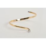 A MODERN 9CT GOLD DIAMOND TORC BANGLE, two modern round brilliant cut diamonds, estimated total