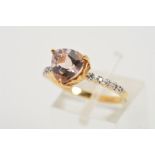 A 9CT GOLD TOPAZ AND DIAMOND DRESS RING, designed as a central, triangular mauve pink topaz within a