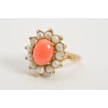 A 9CT GOLD CORAL AND SPLIT PEARL CLUSTER RING, the central coral cabochon within a claw set split