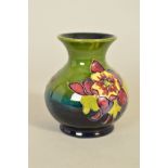 A SMALL MOORCROFT POTTERY BULBOUS VASE, 'Columbine' pattern on green ground, impressed marks to