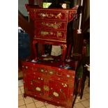AN ORIENTAL RED GROUND CHEST OF THREE DRAWERS flanked with a scrolled top on cabriole legs, width