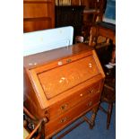 AN OAK BARLEY TWIST FALL FRONT BUREAU and an oak two door cabinet with three drawers (2)