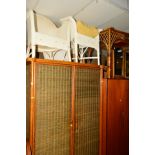 A WICKER AND BAMBOO TWO PIECE BEDROOM SUITE comprising of a two door wardrobe and a dressing table