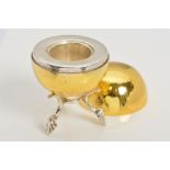 A SILVER GILT SPHERICAL LIDDED CANDLESTICK AND A STAND, the silver gilt lidded sphere opening to a