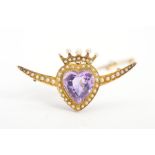 AN EARLY 20TH CENTURY 9CT GOLD AMETHYST AND SEED PEARL HEART BROOCH, the central amethyst heart