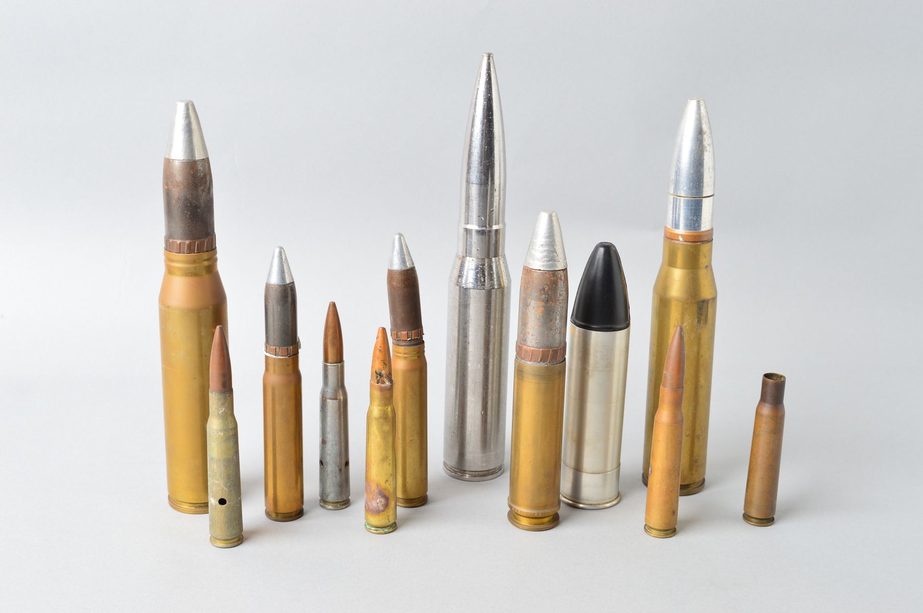 A BOX CONTAINING A NUMBER OF INERT MILITARY SHELLS, 12 in number, various calibres and countries,