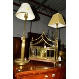A PAIR OF EDWARDIAN STYLE BRASS COLUMN TABLE LAMPS, on a circular base with switches, remnants of
