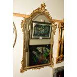 A MODERN FOLIATE GILT FRAMED MIRROR