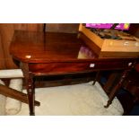 A VICTORIAN MAHOGANY D END TABLE on brass caps and casters, width 108cm x depth 53cm x height 75cm