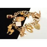 A 9CT GOLD CHARM BRACELET, the curb link bracelet suspending eight charms, to include a row boat,