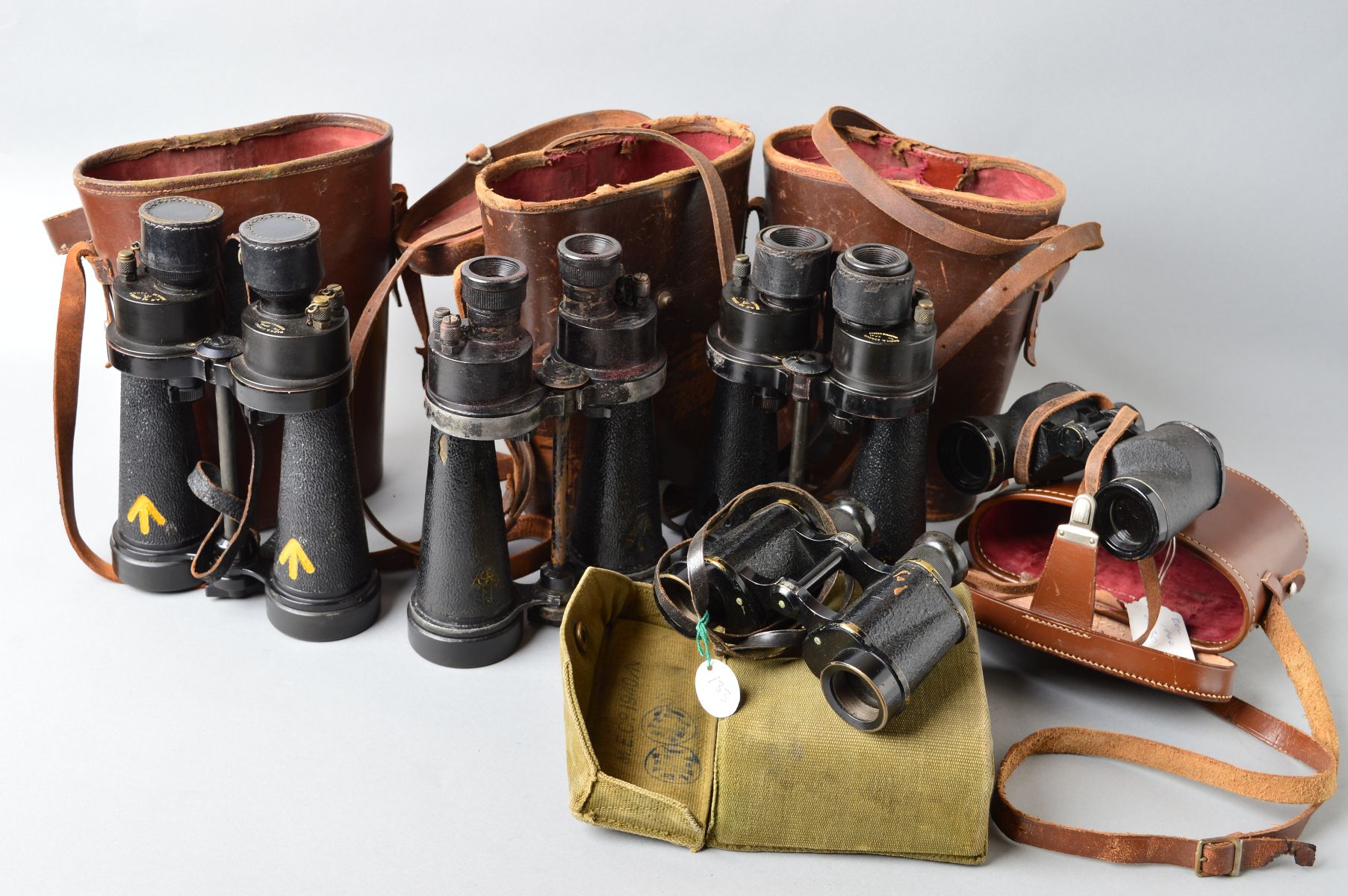 A BOX CONTAINING FIVE PAIRS OF MILITARY ISSUE FIELD BINOCULARS, WWII era as follows, Barr &