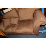 A BROWN UPHOLSTERED TWO SEATER SETTEE together with a striped upholstered wingback armchair (