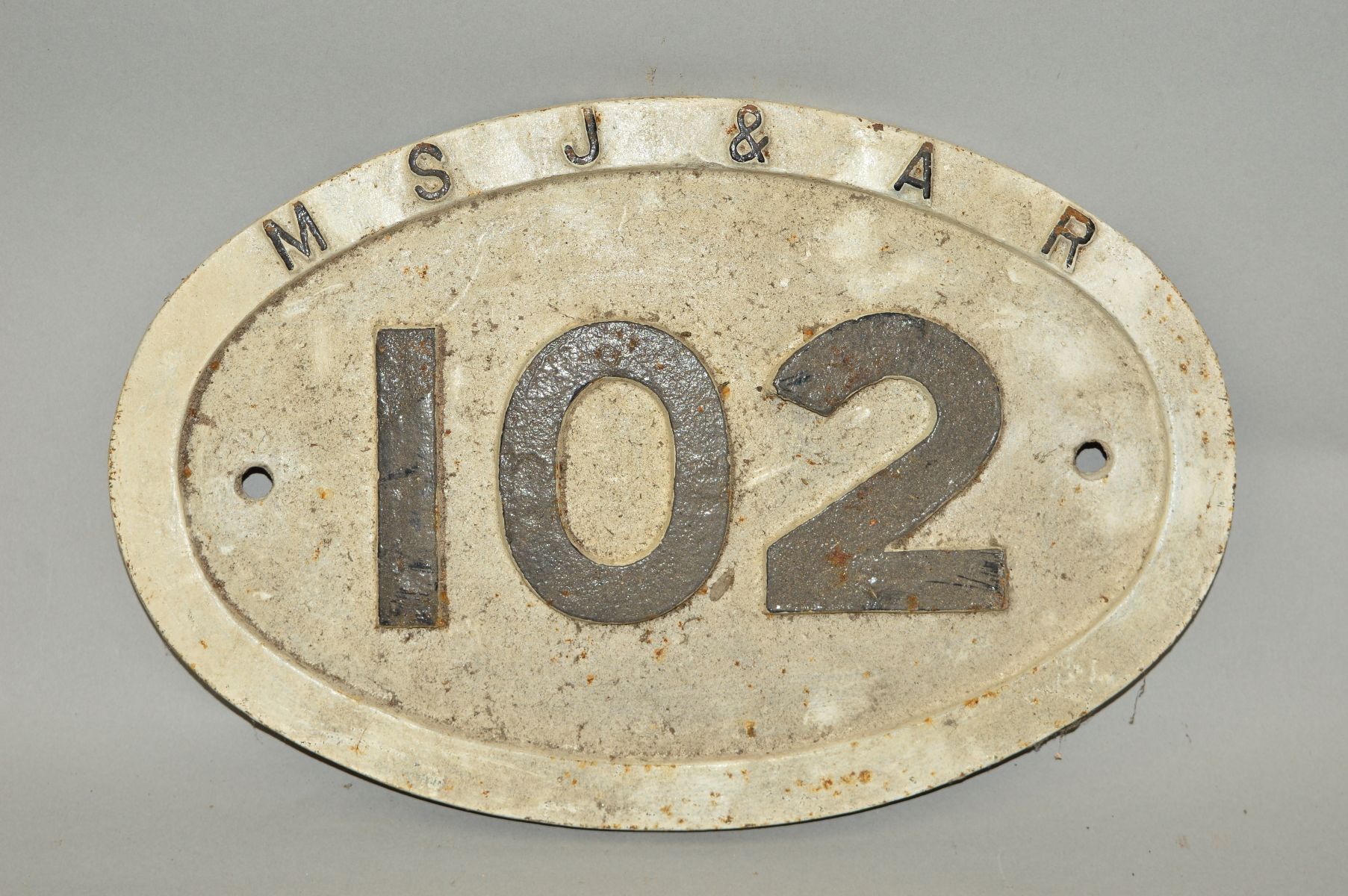 A CAST IRON MANCHESTER SOUTH JUNCTION & ALTRINCHAM RAILWAY BRIDGE PLATE, No.102, raised black