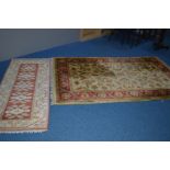 A WOOLLEN FOLIATE DESIGN RUG, red and gold ground, 242cm x 157cm, together with a 20th Century