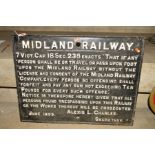 A CAST IRON MIDLAND RAILWAY TRESPASS SIGN, dated 1899, raised white lettering on a black background,