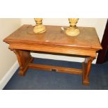 AN EARLY 20TH CENTURY OAK ALTER TABLE, on a pair of scrolled plinths united by a floor stretcher