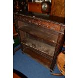 AN EARLY 20TH CENTURY CARVED OAK OPEN BOOKCASE, with three adjustable shelves, width 107cm x depth